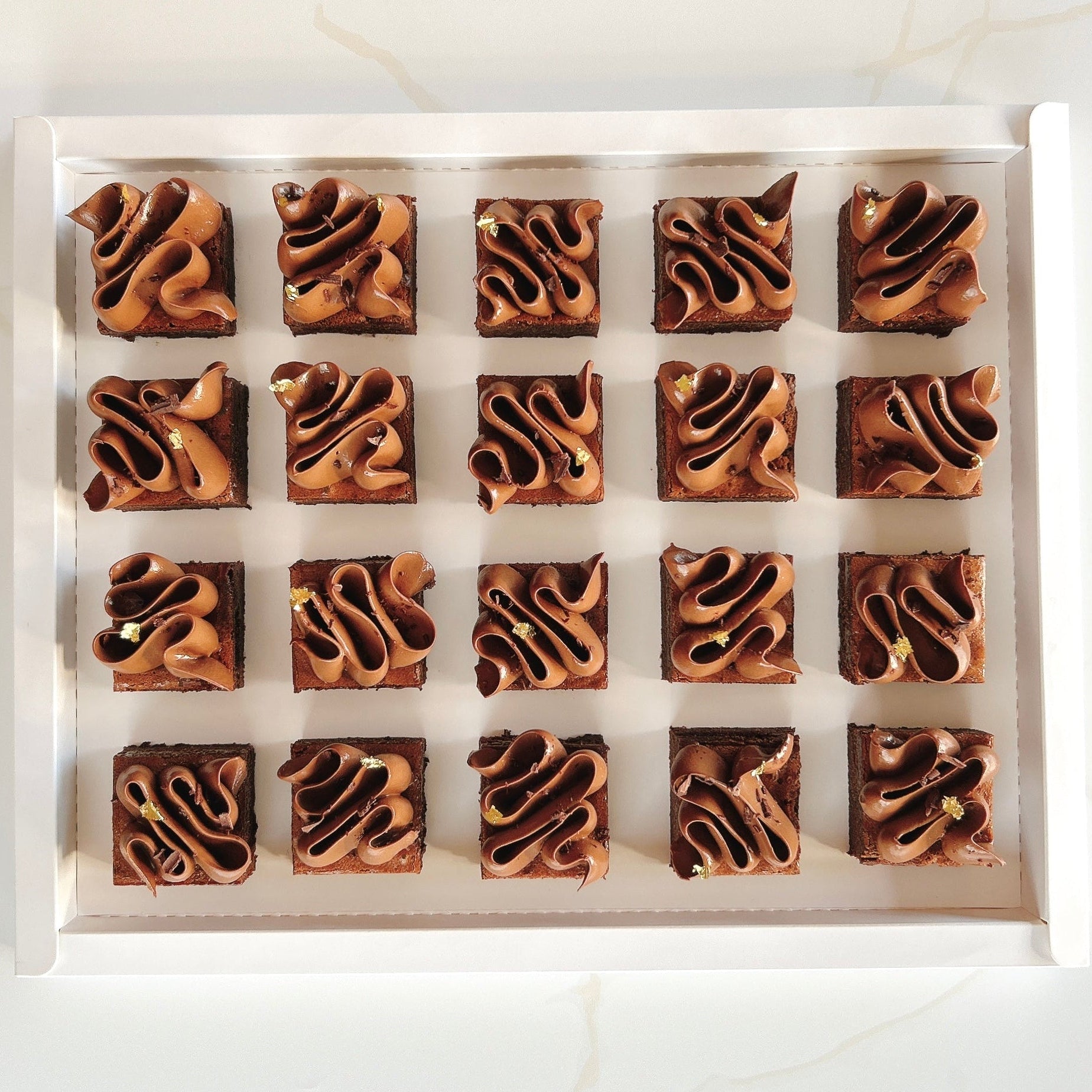 Box of brownies with a swirl pattern on a white background
