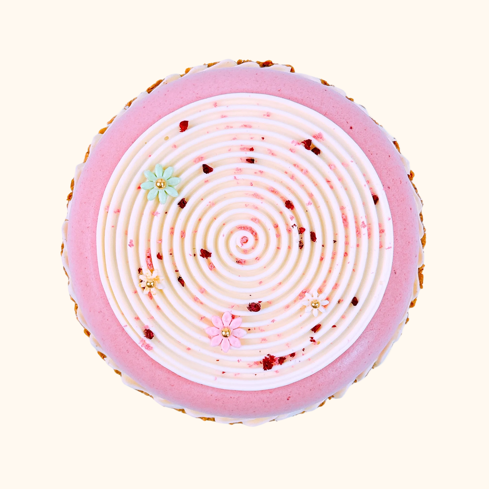 Round pink dessert with concentric circular pattern on a white background