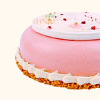 Pink cake with white frosting and a french crispy crepes crust on a white background