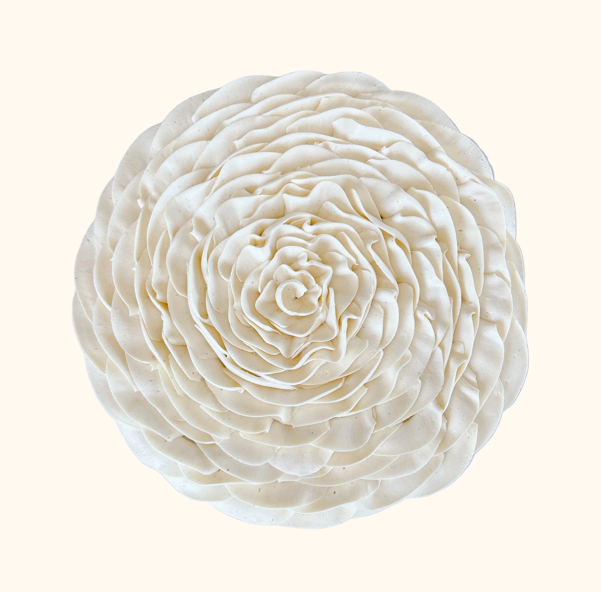 Whipped vanilla ganache flower decor on chocolate fondant
