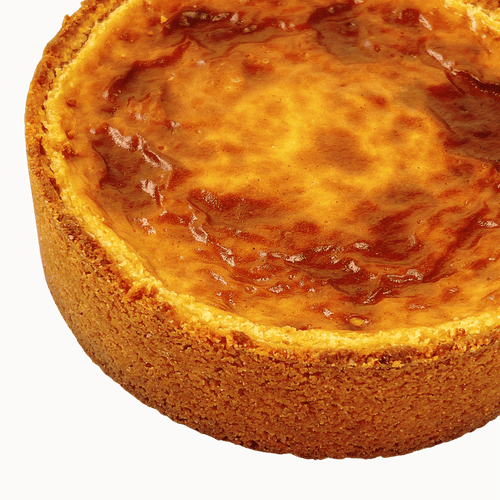 Top view of a traditional French vanilla flan pâtissier with a golden caramelised surface and buttery pastry crust.