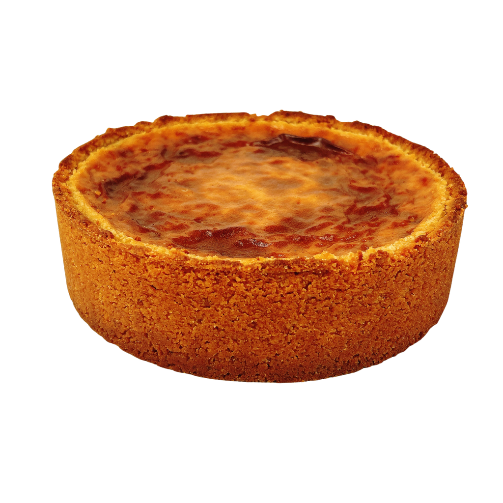 Cross section of a French vanilla flan pâtissier showing its smooth, creamy custard filling inside a crisp buttery pastry crust.