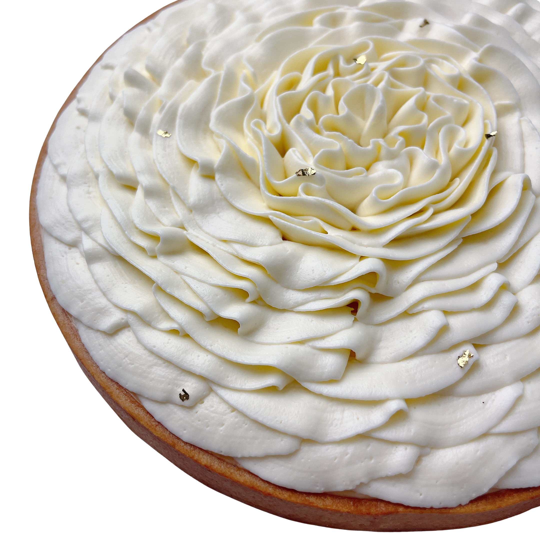 Angled close-up of a handcrafted French lemon tart topped with vanilla whipped cream flower and edible gold leaf.