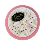 Top view of a Red Berry & Coconut entremet cake with a chocolate Happy Birthday plaque, elegant white spiral décor, sugar flowers and raspberry pieces.